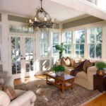Furnished sun room with large windows and glass doors
