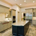 Green luxury kitchen with new cabinets, countertops, island, stainless appliances and geometrical slate floor