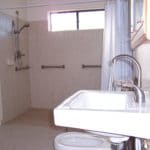 Sierra Remodeling - ADA compliant bathroom with roll-under sink, bidet and wheelchair roll-in shower