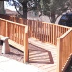 Sierra Remodeling - beautiful redwood wheelchair ramp with safety handrails and gentle turn